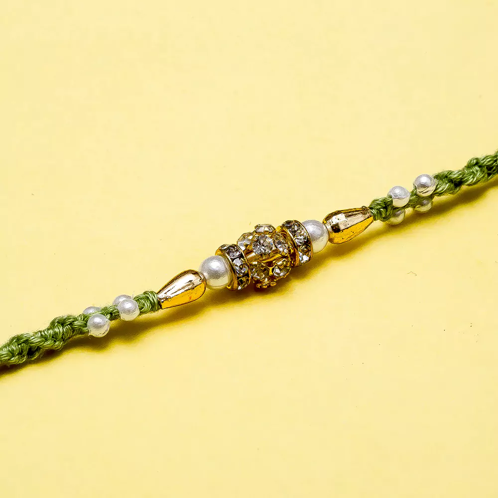 Pearl diamond beads rakhi in green dori